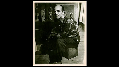 Scene from the video showing a portrait of Borduas, sitting in his studio.